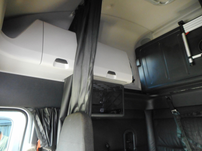 Truck cab interior showing overhead storage compartments and bunk area in a Freightliner Cascadia 126.