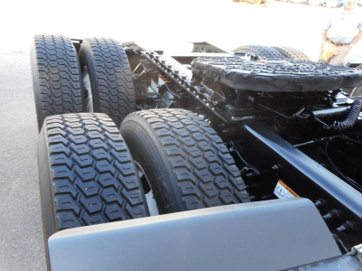 Truck chassis with dual rear axles and tires visible, Freightliner Cascadia 126 cabless chassis frame area