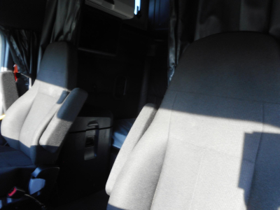 Interior cab view of a Freightliner Cascadia 126 showing front seats and dashboard area.