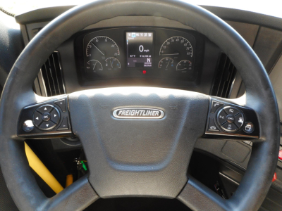 Freightliner Cascadia 126 steering wheel and dashboard with digital gauge cluster and controls on both sides.