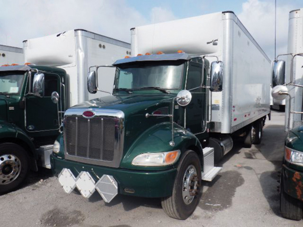 Peterbilt 348 conventional daycab truck with green cab and silver cargo box, front view, chrome grille, two chrome mirrors, startup lights, and diamond plate bumper guards.