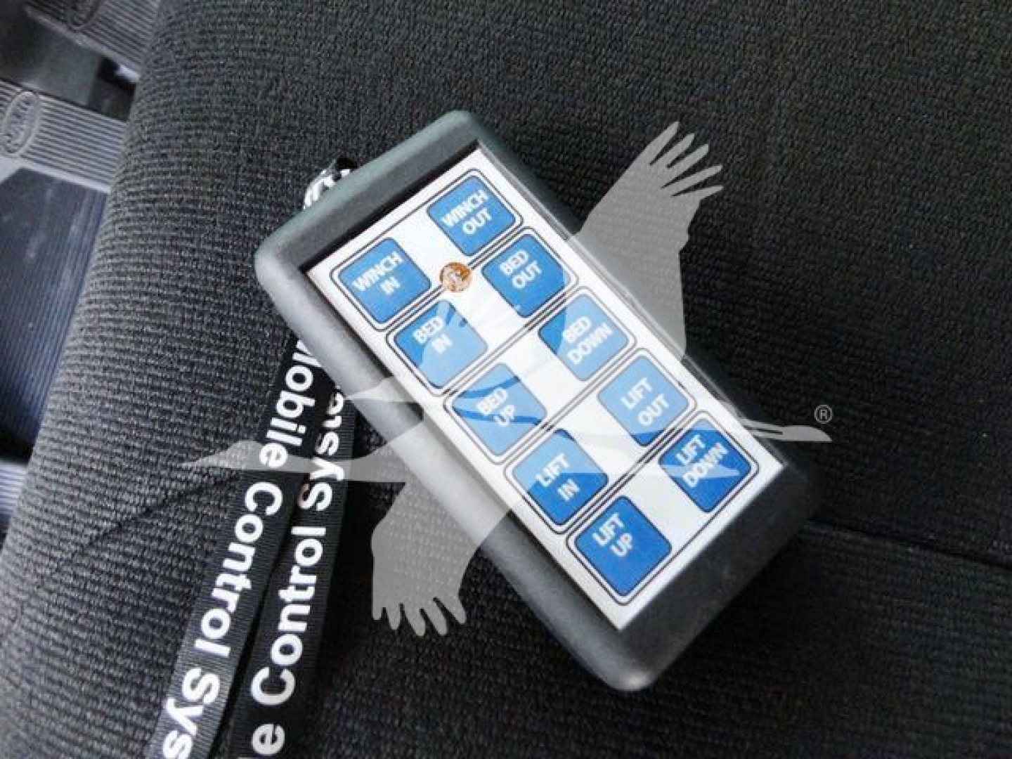 Trucker control switch panel with labeled blue buttons on a seat, for gear and control operations.