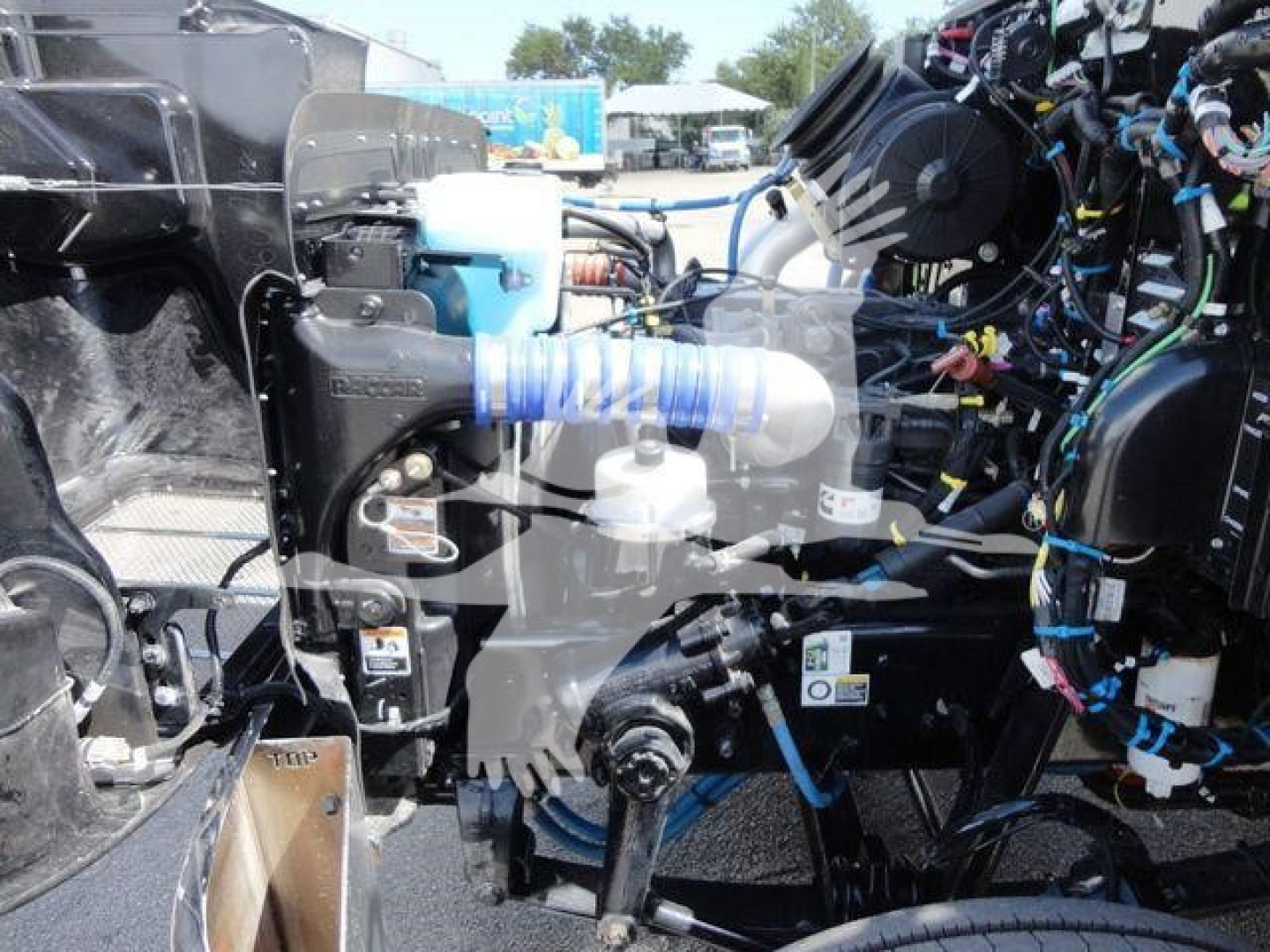 Peterbilt 337 truck engine bay with exposed components and wiring harnesses.