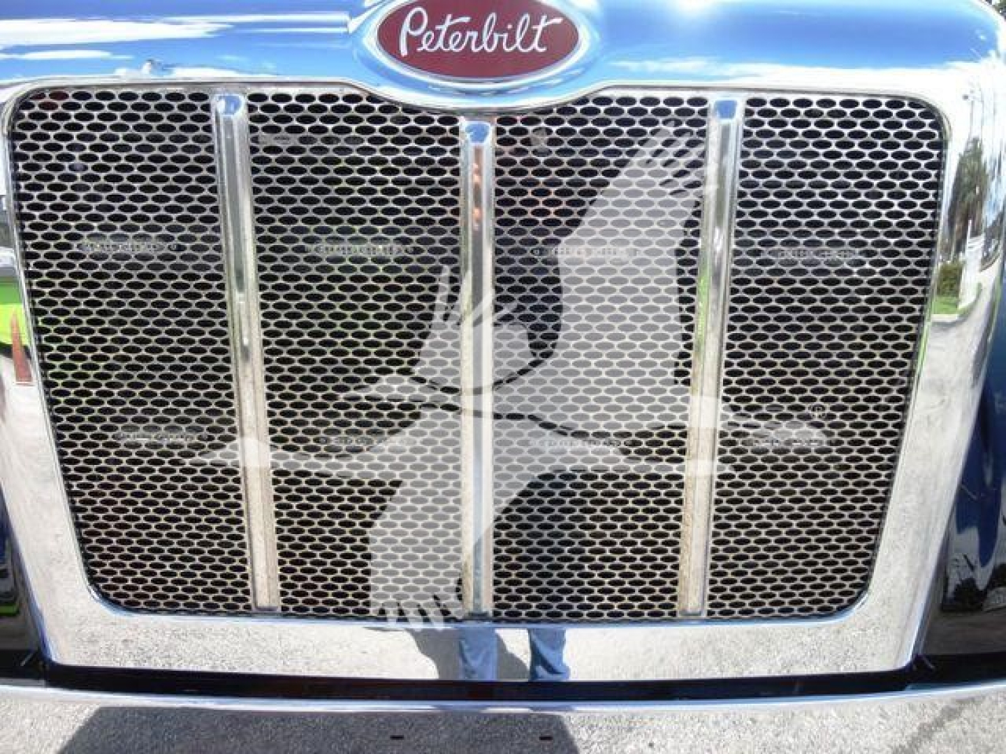 Peterbilt 337 grill with chrome grille and Peterbilt emblem on top; front view of new rollback truck.