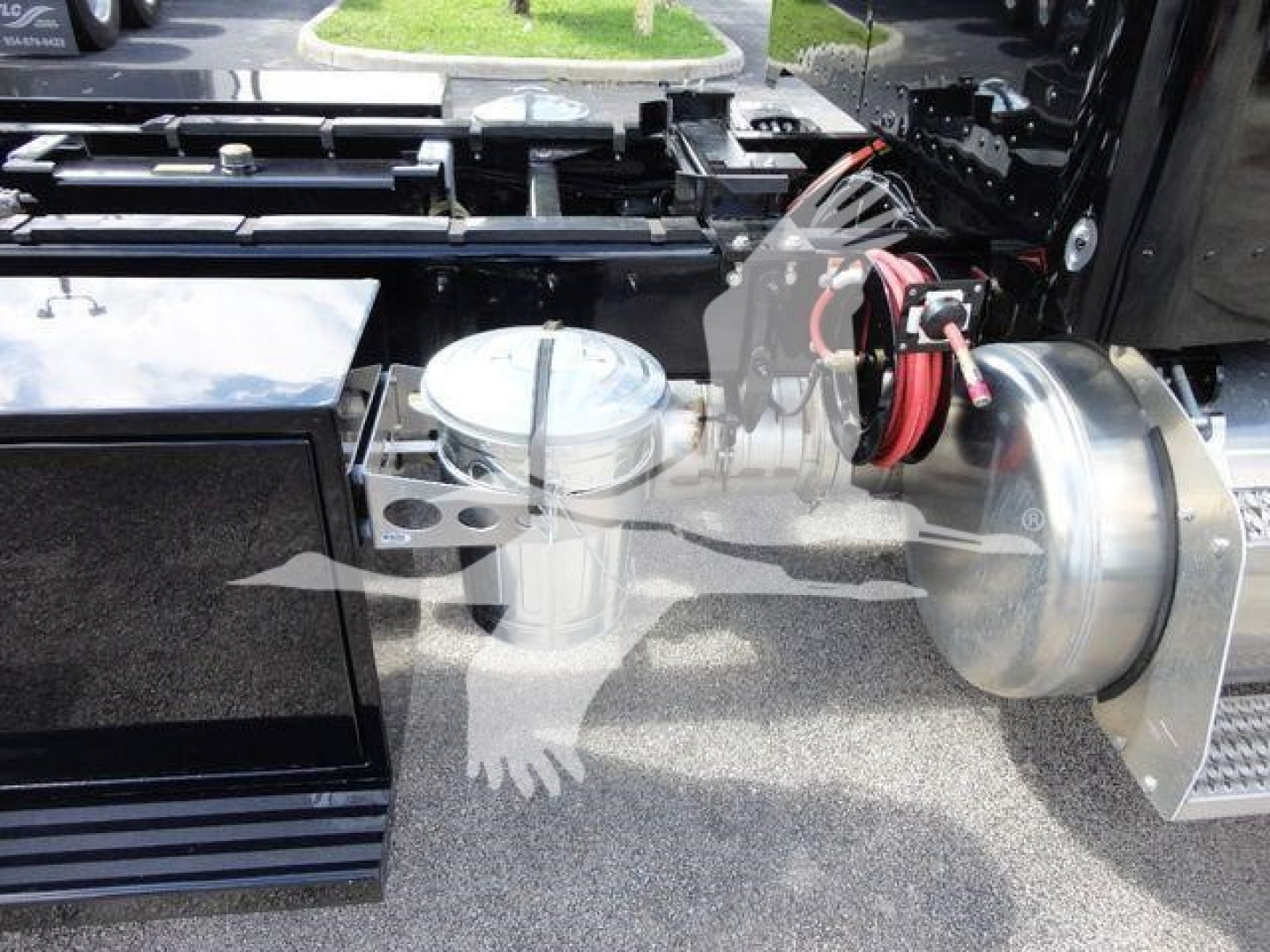 Peterbilt 337 rollback truck chassis showing fuel/air tanks and air line fittings with chrome finishes.