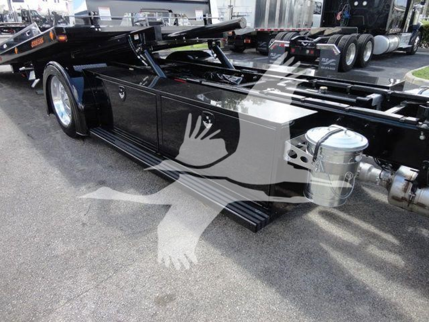 Peterbilt 337 rollback truck chassis showing side silhouette decal and fuel tanks.