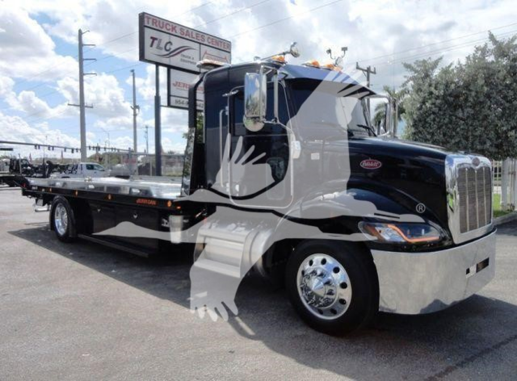 Peterbilt 337 rollback tow truck side view showing black cab and flatbed with chrome accents