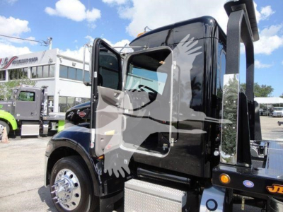 Peterbilt 337 cab/right-side view showing black exterior and rollback equipment mounting.