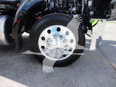 Peterbilt 337 front wheel and diesel engine bay view showing polished chrome hubcap, tire, and front suspension components.