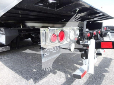 Peterbilt 337 rollback truck rear undercarriage showing chrome bumper with tail lights and hitch hardware.