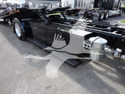 Peterbilt 337 rollback truck chassis showing side silhouette decal and fuel tanks.