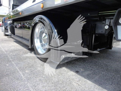 Peterbilt 337 rollback truck side view showing chrome wheel and undercarriage components.