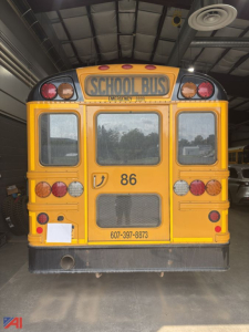 Rear view of a yellow school bus with 'SCHOOL BUS' sign, multiple lights, rear window, and the number 86; contact number 607-397-8873 visible.