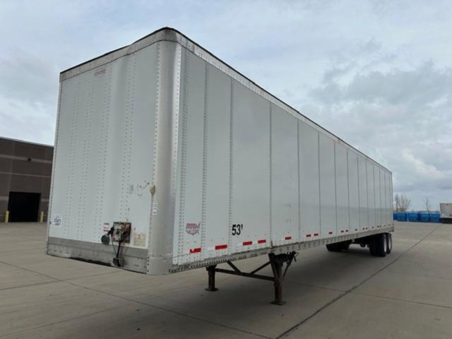 Semi trailer van showing 53' box with hitch and landing gear, side lettering and reflective tape.