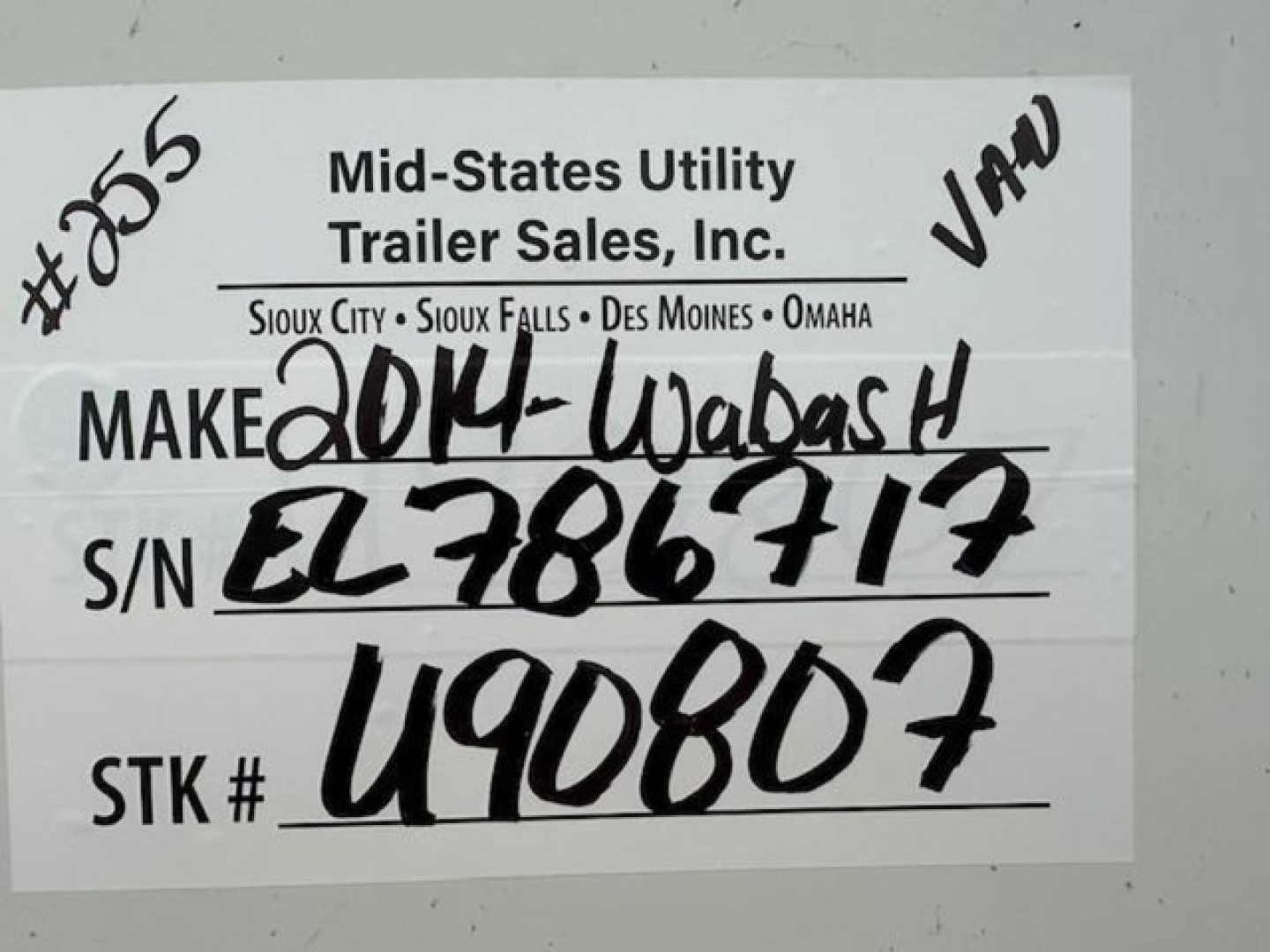 Trailer label on mid-states utility trailer showing Make 2014 Wabash handwritten, S/N EL786717, STK # U90807, U.S. dealer info.