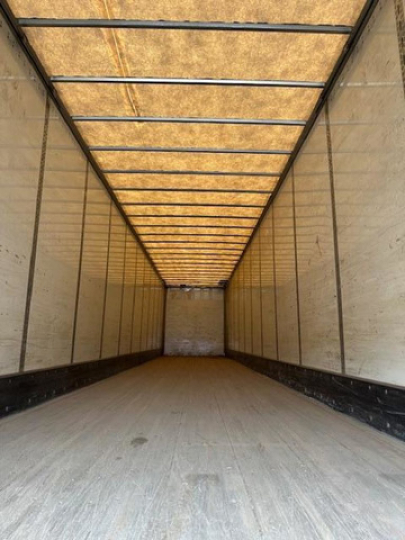 Inside view of a Wabash van trailer cargo space showing side walls, ceiling ribs, and empty floor.