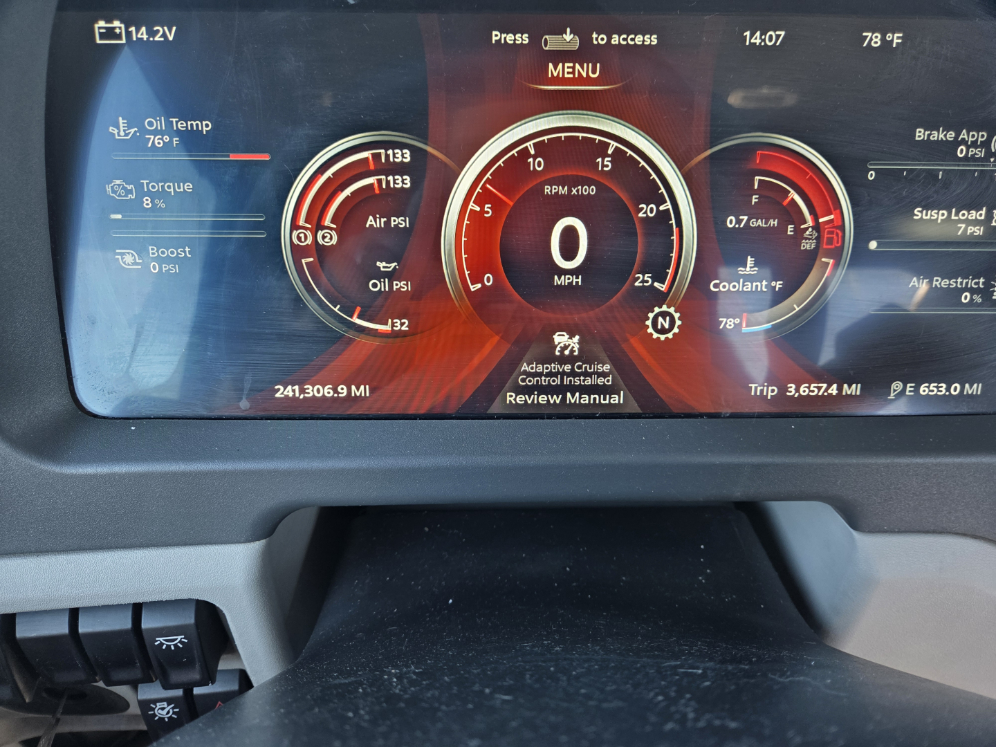Peterbilt 579 instrument cluster display showing RPM gauge at 0, oil temp, oil pressure, boost, and trip metrics; left and right dials with various readings; VIN and stock number not visible on dashboard.