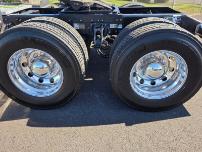 Peterbilt 579 chassis with dual rear wheels showing chrome hubs and tires.