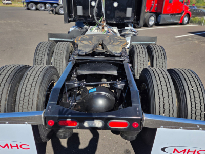Peterbilt 579 chassisView showing rear dual-axle setup and fifth-wheel hitch with multiple air lines and brake components visible.