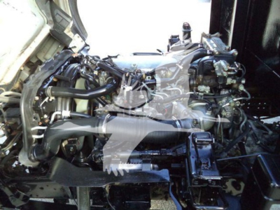 Isuzu NPR/NRR engine bay with exposed diesel engine and components seen from side view.
