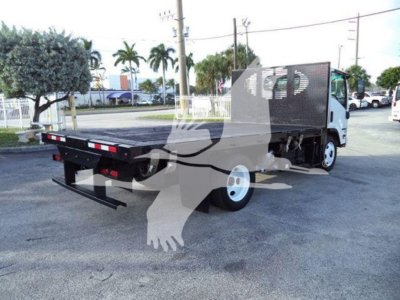 Isuzu NRR flatbed truck rear and side view showing flatbed with black metal deck and rear bumper, white cab, side rails, and flatbed undercarriage.