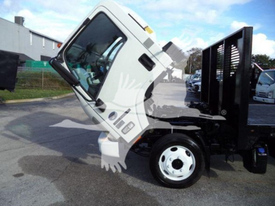 Isuzu NRR flatbed truck cab and chassis, angled side view, with white cab and black dump bed, front wheel visible.