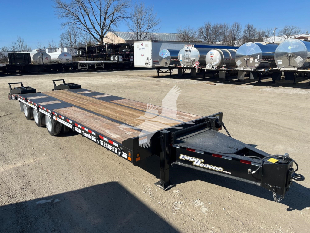Trailer showing a long flatbed used for hauling with multiple axles and a gooseneck hitch. Brand 'Eager Beaver' on the tongue and model 25XPL visible.