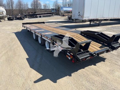 Flatbed trailer showing dual rear ramps and wooden deck with steel framing and triple axle wheels.