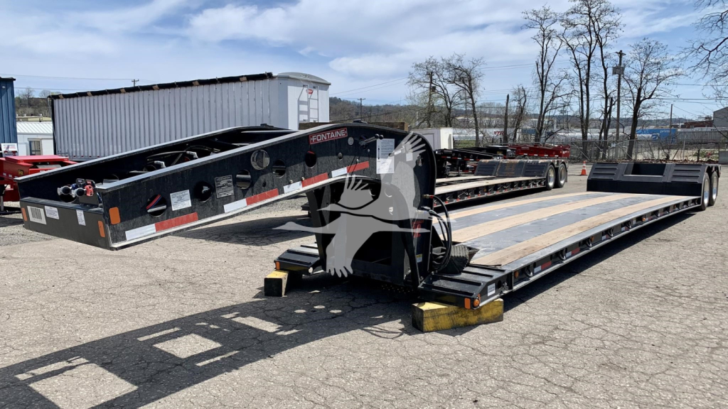Lowboy trailer in an outdoor lot with a Fontaine Renegade N12 label, side rails, and wooden deck sections visible. Text on image includes 2027 Fontaine Renegade N12, VIN 13N35320XV35A6655, Stock Number V35A6655, Category Lowboy, Type Traile