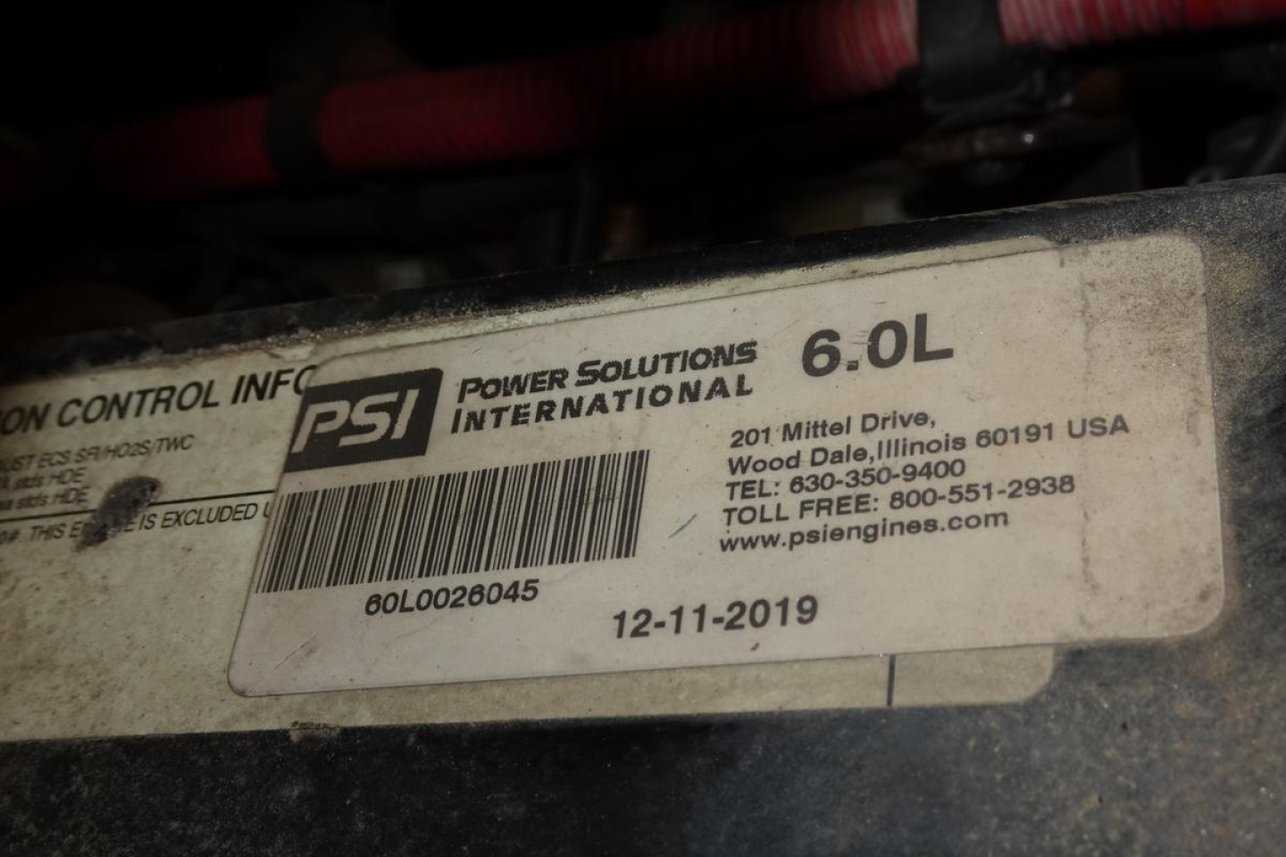 PSI Power Solutions International label on engine showing 6.0L and PSI part numbers and date, with VIN and contact details partially visible.