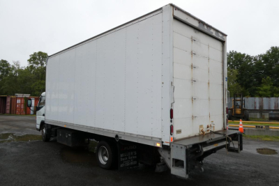 Box truck with cargo box and rear ramp door of a 2019 Mitsubishi Fuso Canter FE140, side view showing rear doors.