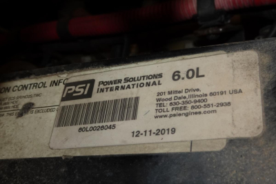 PSI Power Solutions International label on engine showing 6.0L and PSI part numbers and date, with VIN and contact details partially visible.