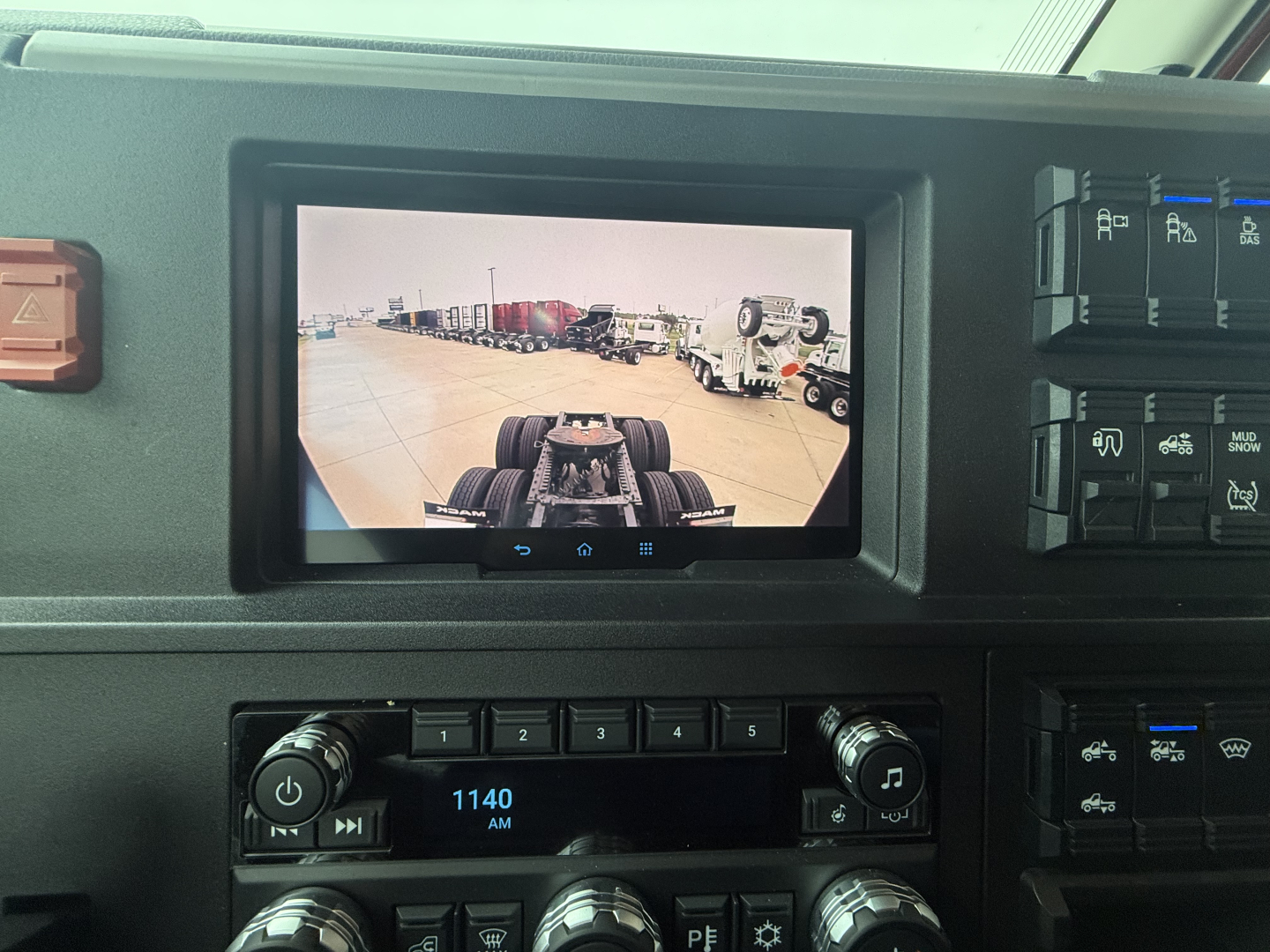 Dashboard of a new 2026 Mack PR64T76H truck showing the touchscreen display and control panel with radio and climate controls.