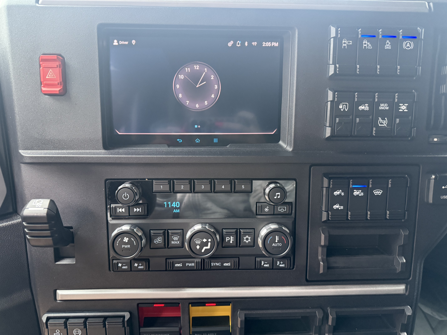 Mack PR64T76H truck interior dash cluster with digital display and control panels showing climate and multimedia controls.