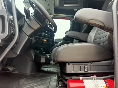 Cab interior of a 2026 Mack PR64T76H truck showing driver seat, steering wheel, and dashboard with control panels.