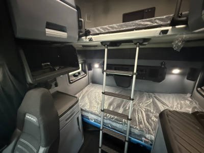 Mack PR64T76H truck cab interior showing stacked sleeper bunks with ladder and storage compartments.