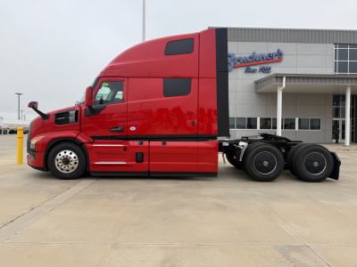 Mack PR64T76H tractor cab side view showing red exterior and sleeper cab.