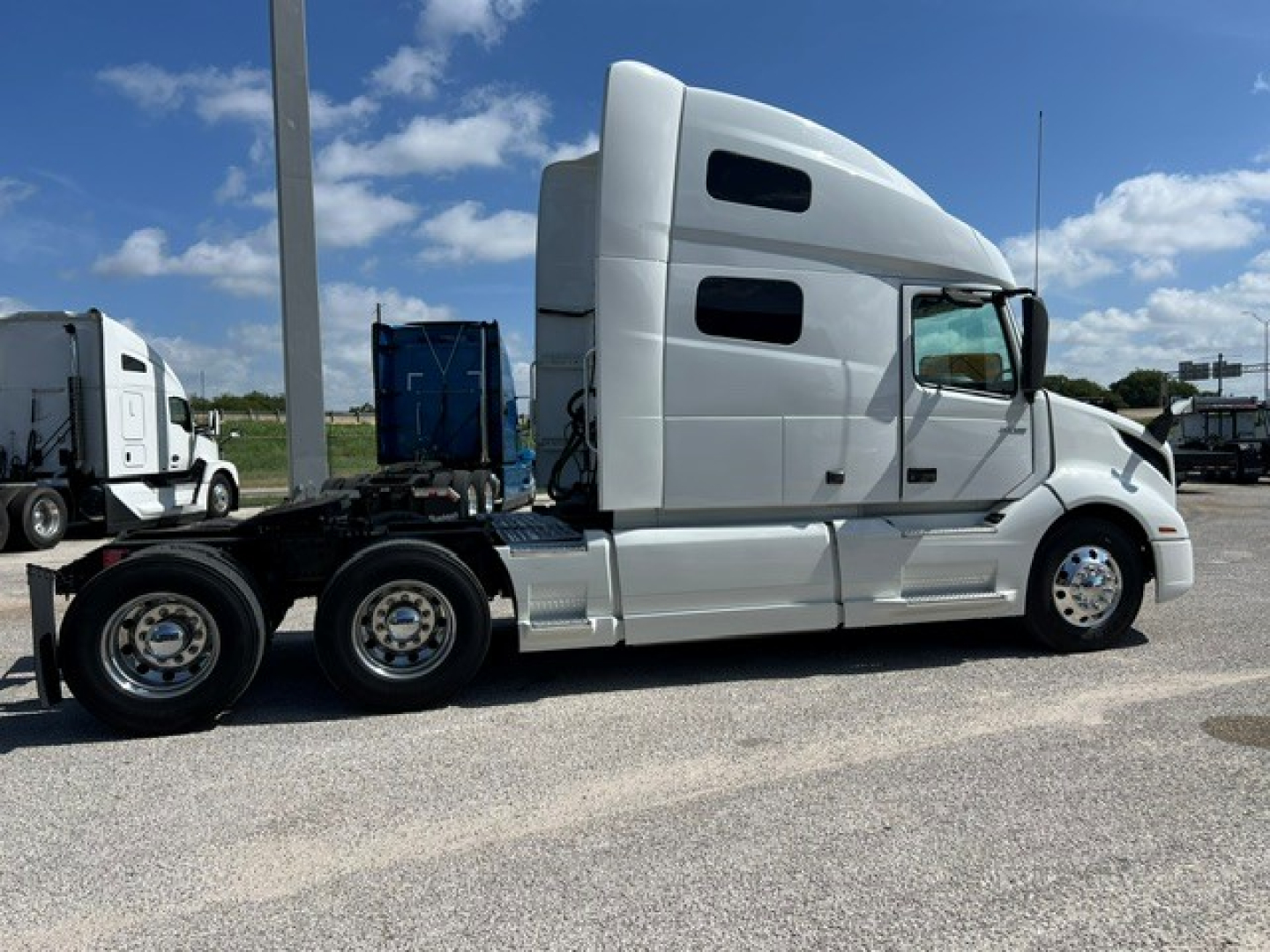 Volvo VNL64T760 truck side profile showing sleeper cab and dual rear axles with chrome wheels.