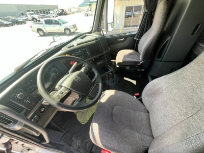 Cab interior of a 2020 Volvo VNL64T760 truck showing steering wheel, dashboard, driver seat, and passenger seat.