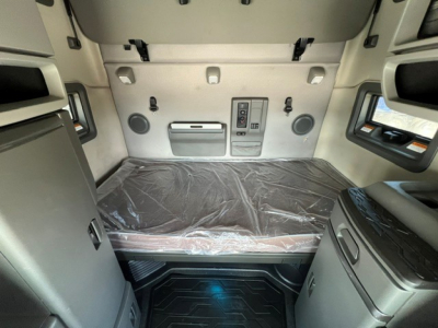 Interior sleeper cab of a 2020 Volvo VNL64T760 showing bed with plastic cover and storage compartments.