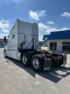 Volvo VNL64T760 sleeper cab tractor showing rear view with dual rear axles and fifth wheel.
