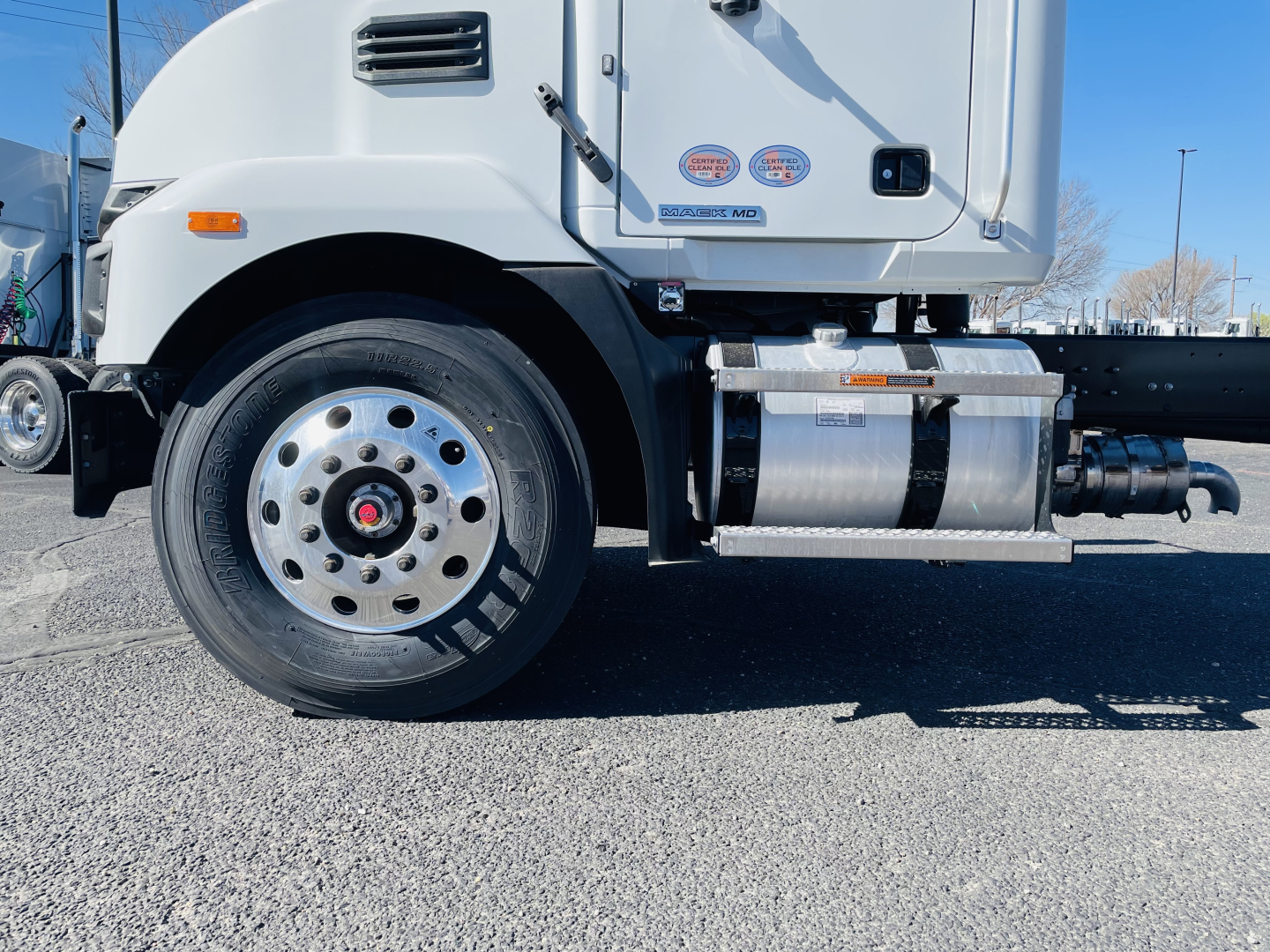Mack MD6 truck front wheel area showing side fuel tank and chassis components.