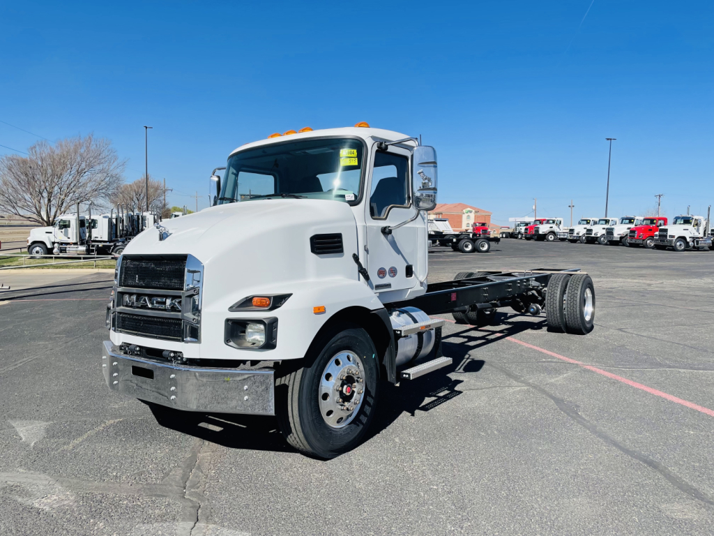 Mack MD6 cab located in a bright lot; front grille with Mack logo; engine bay not visible; no visible text other than generic truck features.