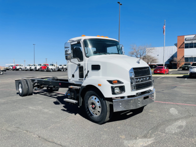 Mack MD6 cab chassis truck in a parking lot, front-right view, with white cab and flatbed chassis, serial VIN 1M2MDBAA1TS018844 visible in listing context.