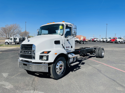 Mack MD6 cab located in a bright lot; front grille with Mack logo; engine bay not visible; no visible text other than generic truck features.