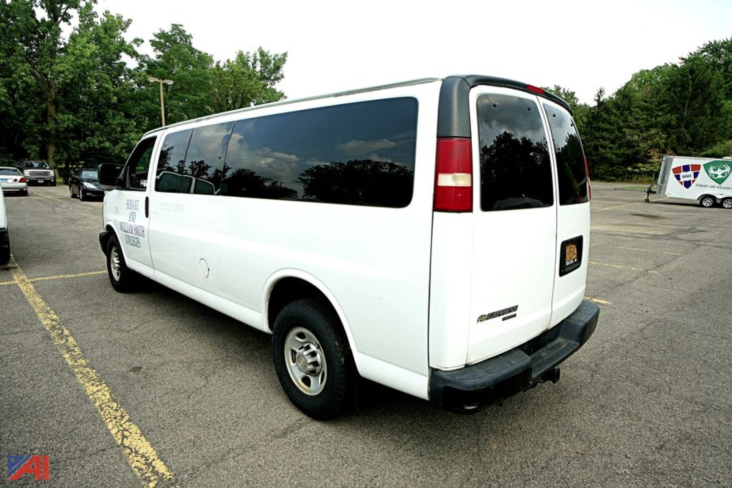 Chevrolet Express 3500 passenger van rear three-quarter view showing white body, tinted windows, and rear bumper.