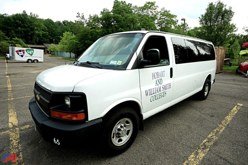 Chevrolet Express 3500 passenger van in white with Hobart and William Smith Colleges branding on the side, shown in a parking lot.