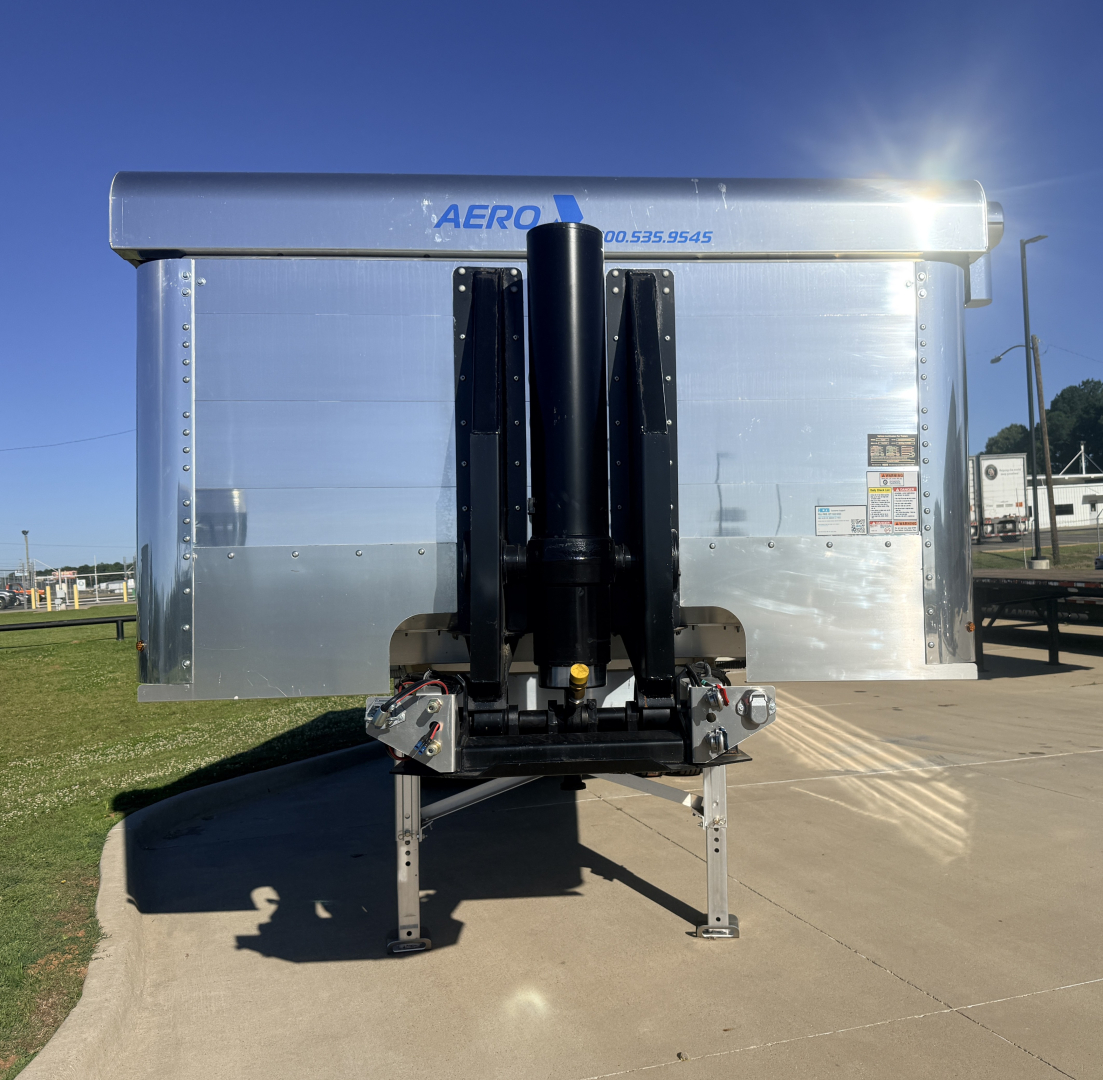 AERO trailer rear view showing hydraulic cylinder hitch and silver aluminum sides.