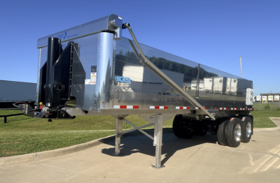 Hicks 2026 FL2827 dump trailer with shiny metal sides, dual rear axles, and front hitch. CABIN? No text visible except small Hicks logo on side.