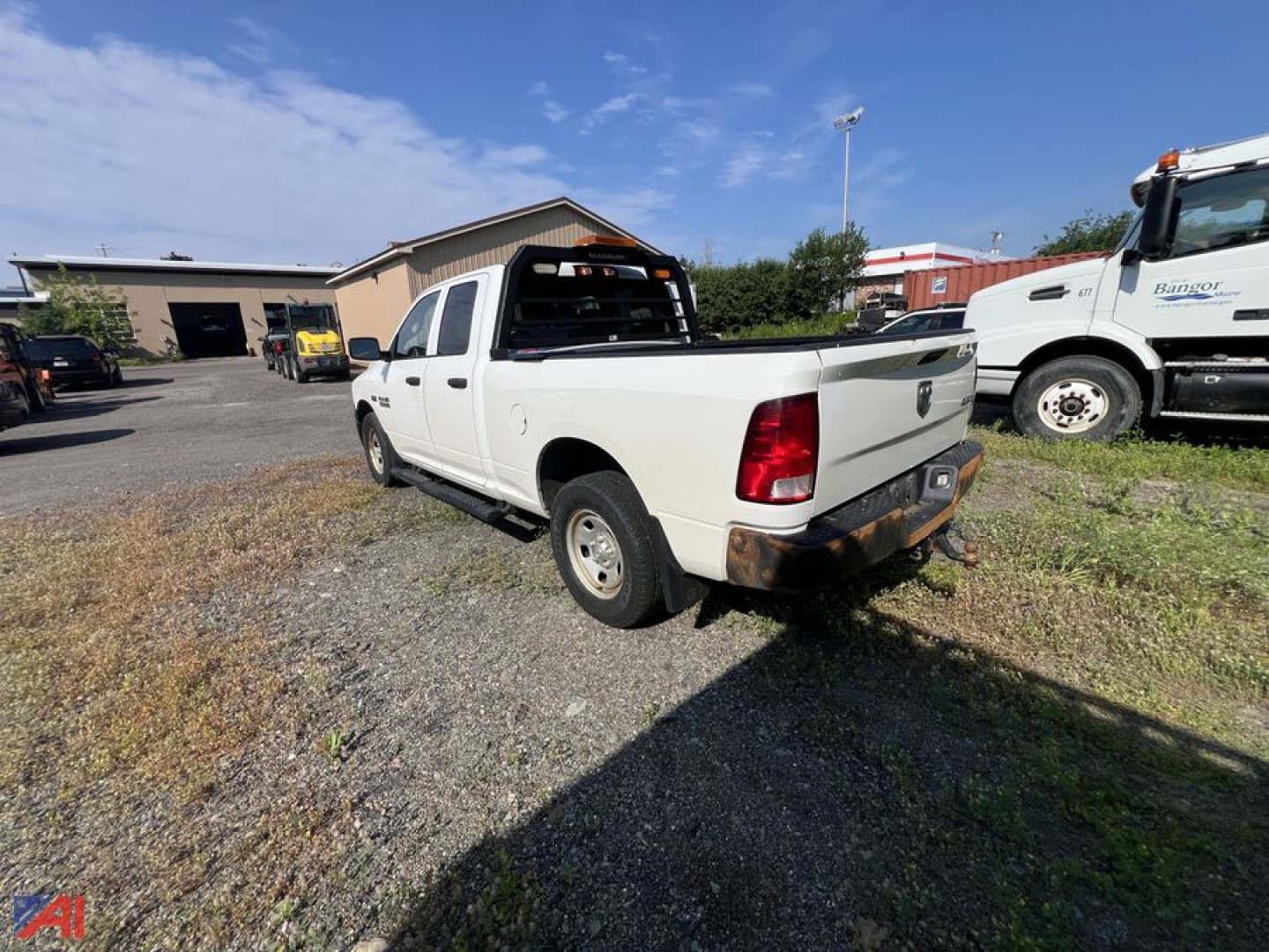 Pickup truck showing Ram Tradesman 4x4 tailgate and rear lights in a used lot.